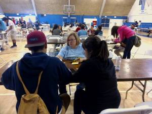 Center fro Financial Empowerment Manager Abby Ulm helping students during Mad City Money reality fair at Duarte HS.